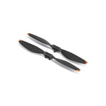 Two black propellers with orange accents on a white background