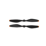Two black propellers with orange accents on a white background
