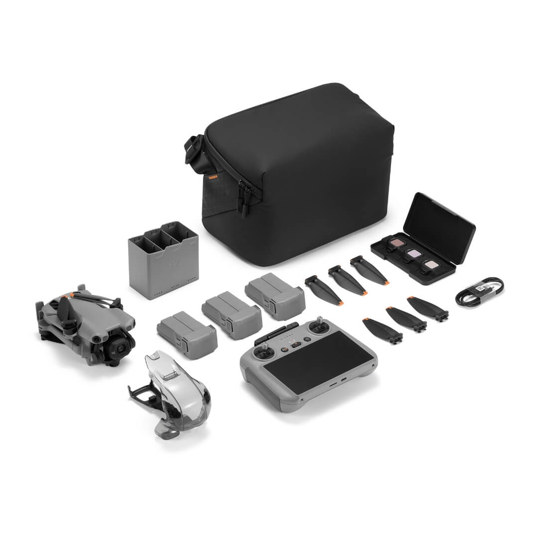 Drone, 3 batteries, remote controller, storage bag and accessories on a white background from front right angle