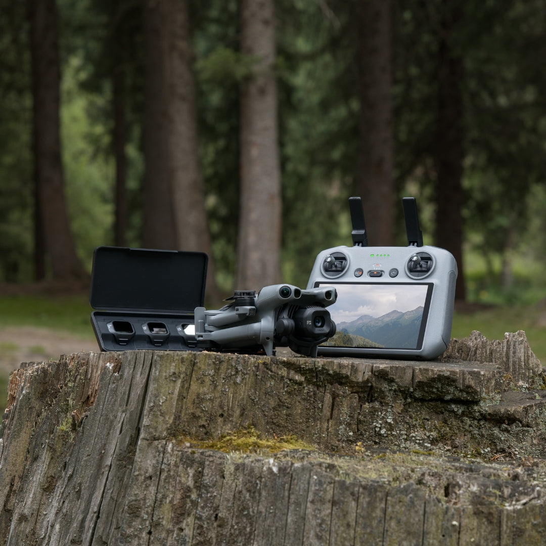 Mini 5 Pro drone with RC 2 controller and ND filter set on a wooden stump with a forest background
