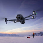 Mavic 4 Pro drone flying over a snowy landscape with a person in the background
