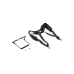 Camera shoulder harness with small rectangular device top-down right 45-degree view on white background