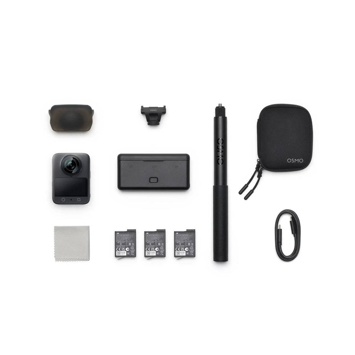 Osmo 360 camera with Adventure Combo with selfie stick, protective pouch, multiple batteries and cables from birds-eye view on a white background