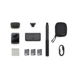 Osmo 360 camera with Adventure Combo with selfie stick, protective pouch, multiple batteries and cables from birds-eye view on a white background